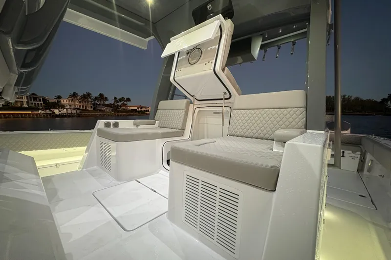  Yacht Photos Pics Luxurious interior of 2026 HCB 56 Suenos GIX boat at sunset, featuring elegant seating.