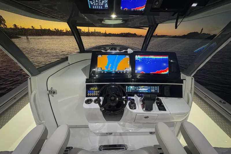  Yacht Photos Pics Helm of 2026 HCB 56 Suenos GIX yacht with advanced navigation displays at sunset.