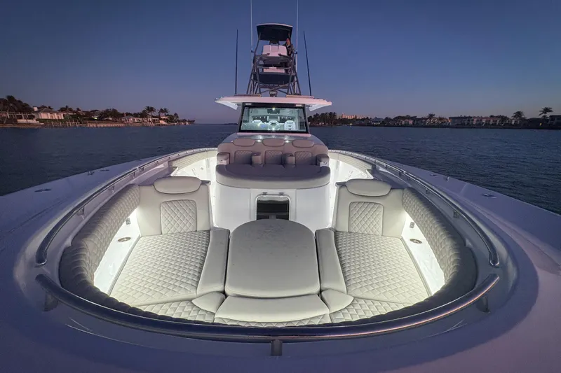  Yacht Photos Pics Luxurious 2026 HCB 56 Suenos GIX yacht with illuminated seating at dusk.