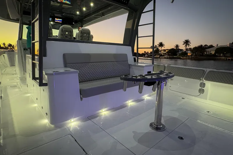  Yacht Photos Pics Luxurious 2026 HCB 56 Suenos GIX boat interior at sunset, featuring elegant seating and ambient lighting.