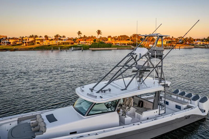  Yacht Photos Pics 2026 HCB 56 Suenos GIX yacht cruising on a serene waterway at sunset.