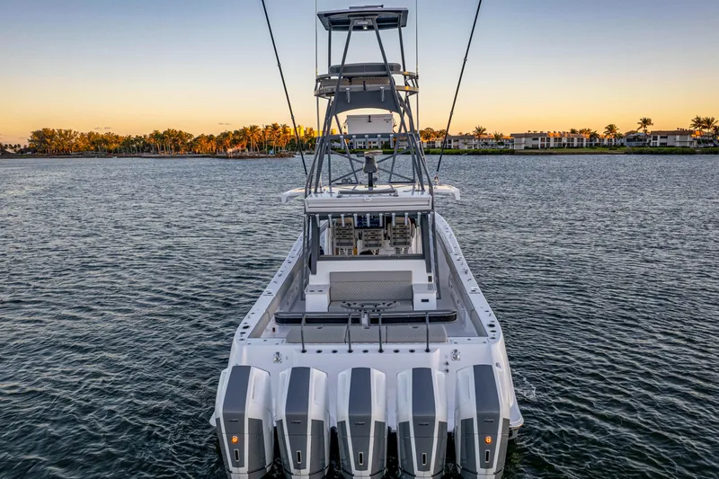  Yacht Photos Pics 2026 HCB 56 Suenos GIX boat with multiple engines on calm water at sunset.