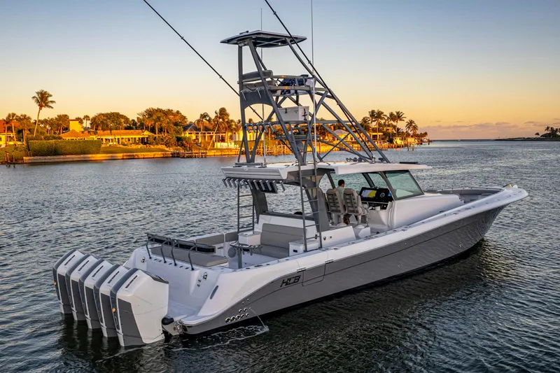  Yacht Photos Pics 2026 HCB 56 Suenos GIX luxury boat on serene water at sunset.