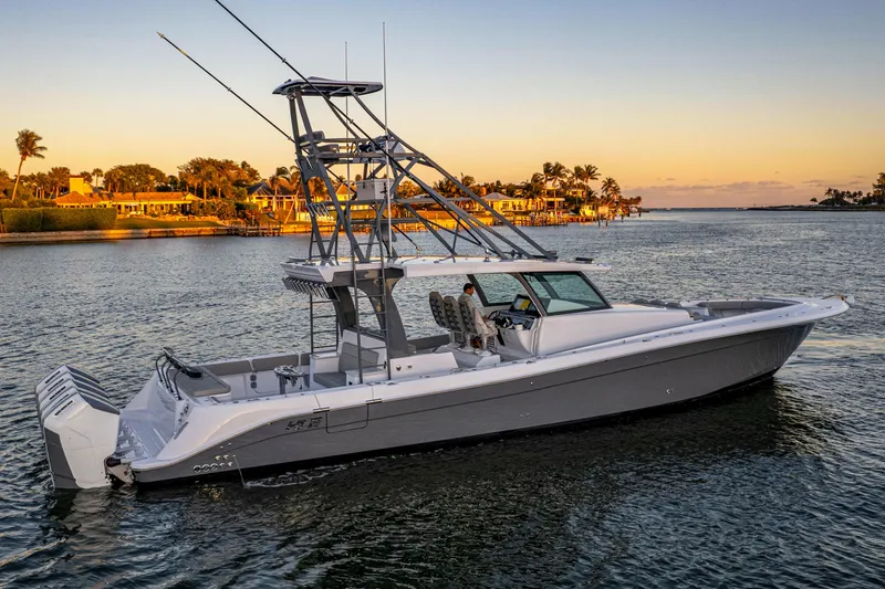  Yacht Photos Pics 2026 HCB 56 Suenos GIX luxury boat cruising at sunset near waterfront homes.