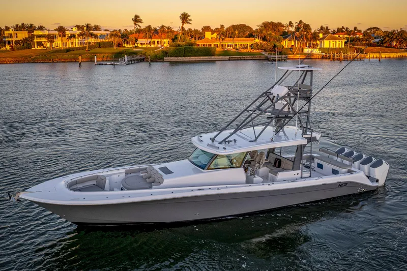  Yacht Photos Pics 2026 HCB 56 Suenos GIX luxury boat cruising near waterfront homes at sunset.