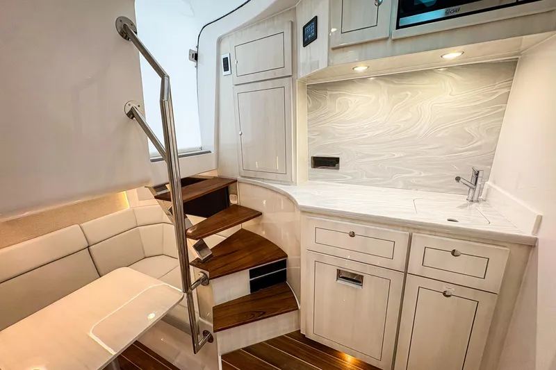  Yacht Photos Pics Luxurious interior of 2026 HCB 56 Suenos GIX yacht with modern kitchenette and seating area.