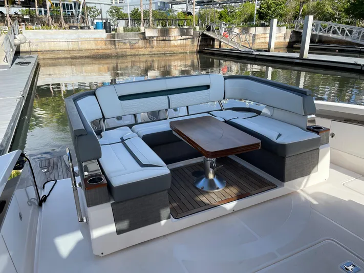  Yacht Photos Pics 2020 Tiara Yachts 38 LS with spacious seating and wooden table at the dock.