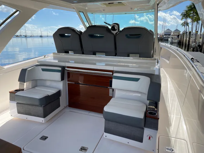  Yacht Photos Pics 2020 Tiara Yachts 38 LS interior with seating and helm, docked at marina.