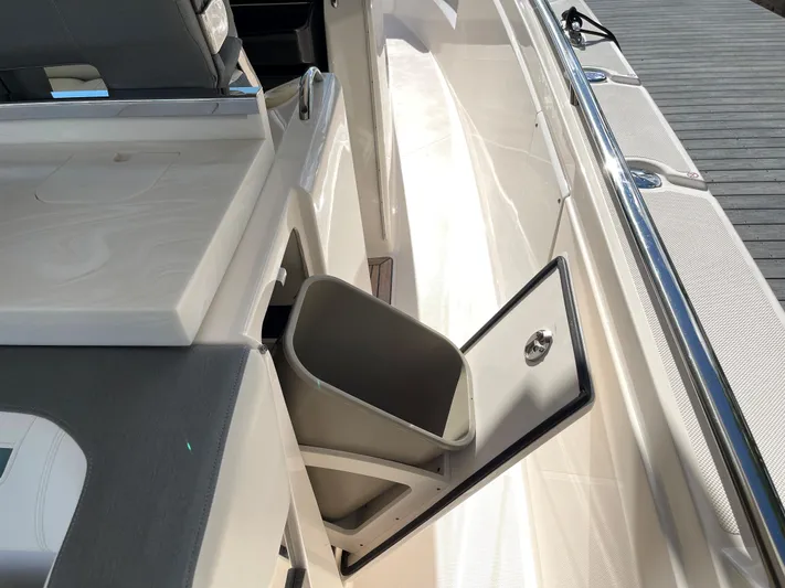  Yacht Photos Pics Tiara Yachts 38 LS 2020 model with an open storage compartment and trash bin.