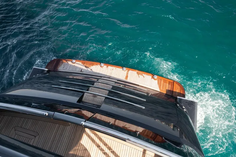 Spectre Yacht Photos Pics Aerial view of 2004 Azimut 100 Jumbo yacht on turquoise water.