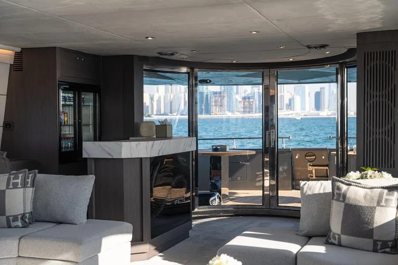 Spectre Yacht Photos Pics Luxurious interior of 2004 Azimut 100 Jumbo yacht with ocean view through glass doors.