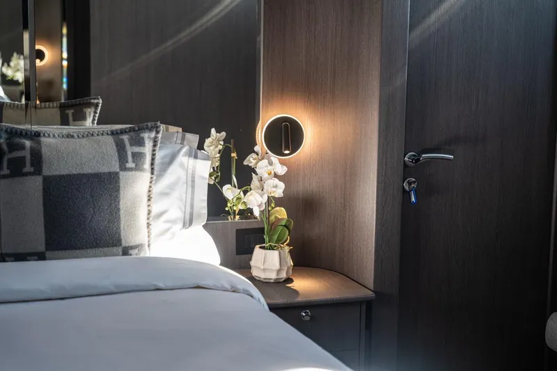 Spectre Yacht Photos Pics Luxurious bedroom interior on 2004 Azimut 100 Jumbo yacht, featuring elegant decor and soft lighting.