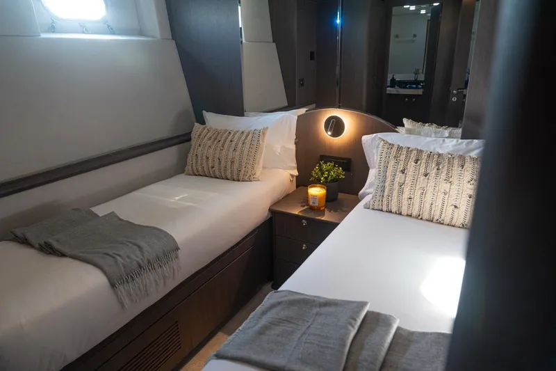 Spectre Yacht Photos Pics Luxurious twin cabin interior on 2004 Azimut 100 Jumbo yacht, featuring elegant bedding and decor.