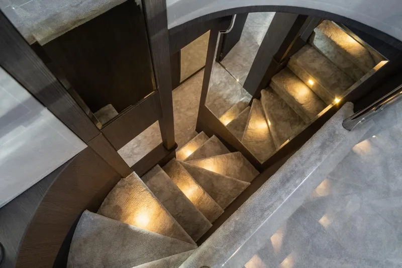 Spectre Yacht Photos Pics Luxurious carpeted staircase with ambient lighting on 2004 Azimut 100 Jumbo yacht.