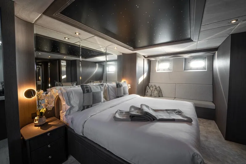 Spectre Yacht Photos Pics Luxurious bedroom interior of 2004 Azimut 100 Jumbo yacht with elegant decor and ambient lighting.
