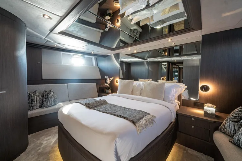 Spectre Yacht Photos Pics Luxurious bedroom interior on 2004 Azimut 100 Jumbo yacht, featuring elegant decor and modern amenities.