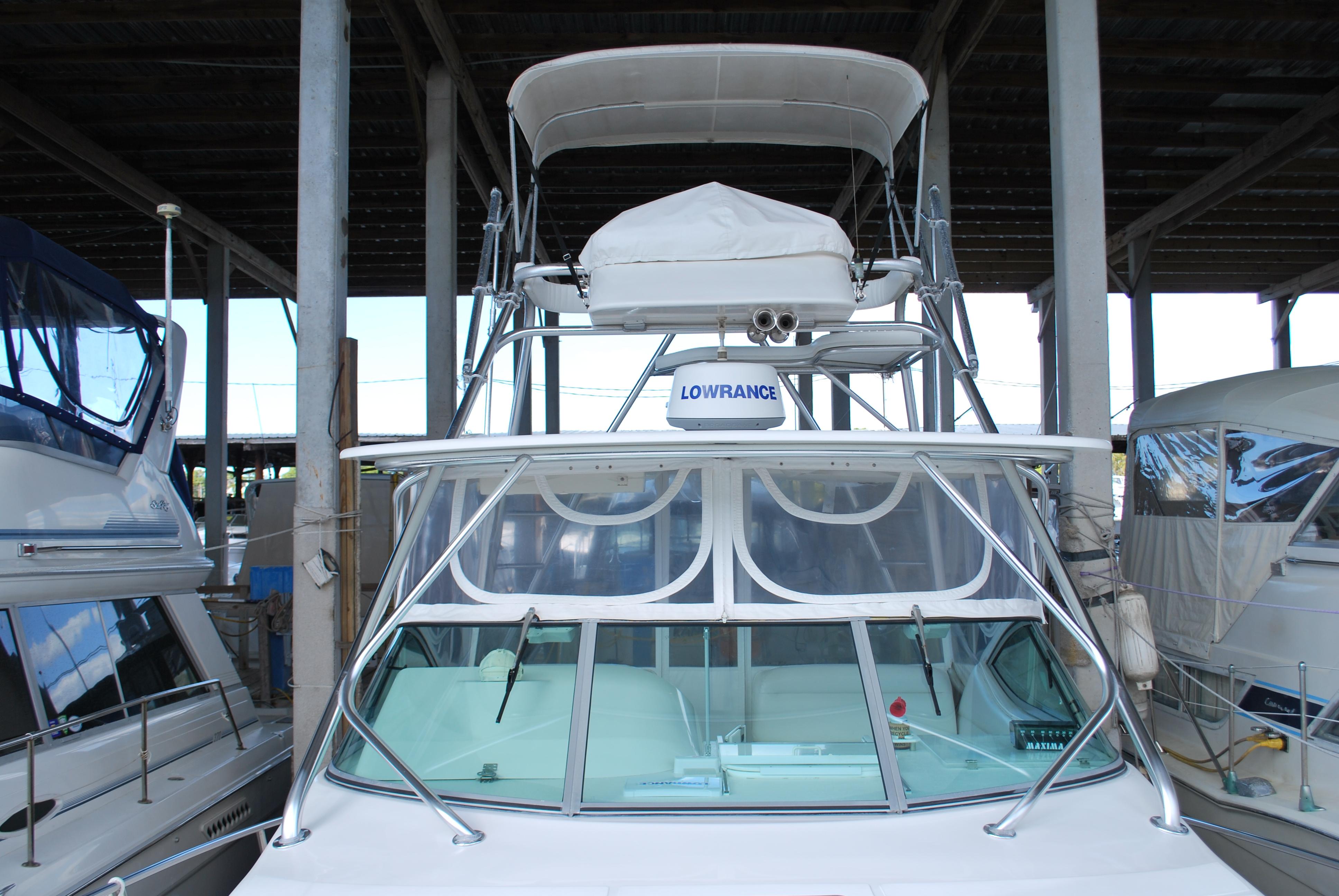 2005 Stamas 370 Express boat docked in a covered marina.