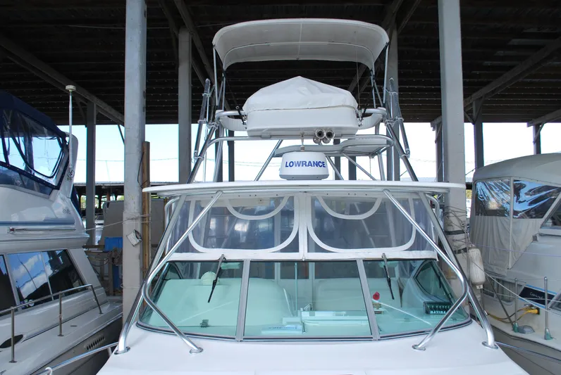  Yacht Photos Pics 2005 Stamas 370 Express boat docked in a covered marina.