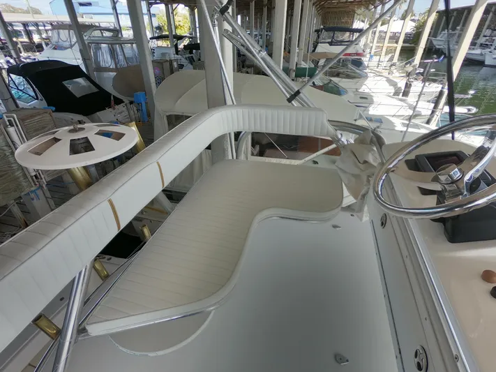  Yacht Photos Pics 2005 Stamas 370 Express boat interior with white seating and steering wheel.