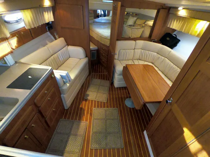  Yacht Photos Pics Interior of 2005 Stamas 370 Express yacht with cozy seating and wooden finishes.