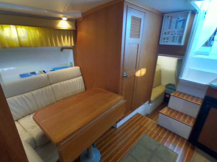  Yacht Photos Pics 2005 Stamas 370 Express cabin interior with wooden table, seating, and stairs.