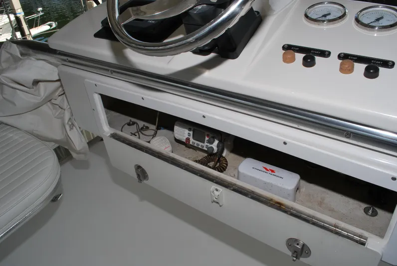  Yacht Photos Pics 2005 Stamas 370 Express boat dashboard with open storage compartment and gauges.