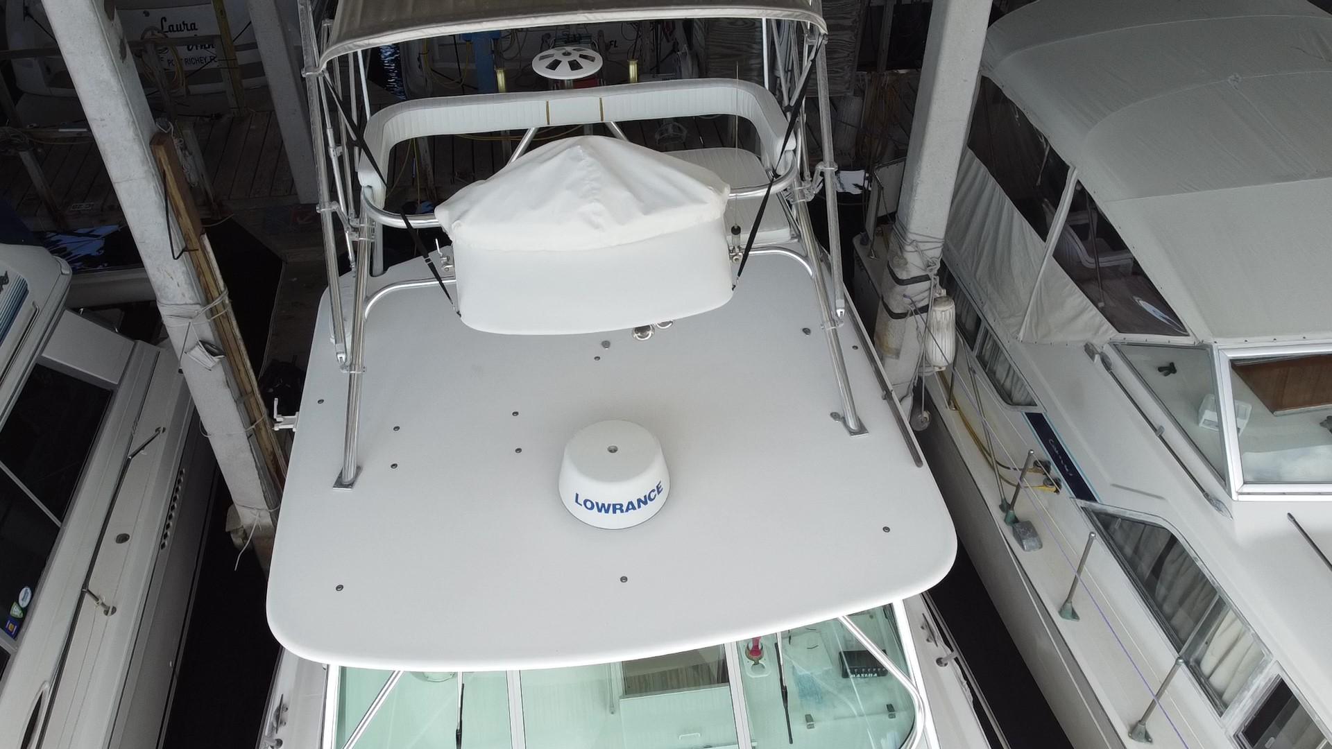 2005 Stamas 370 Express boat with radar equipment, docked among other vessels.