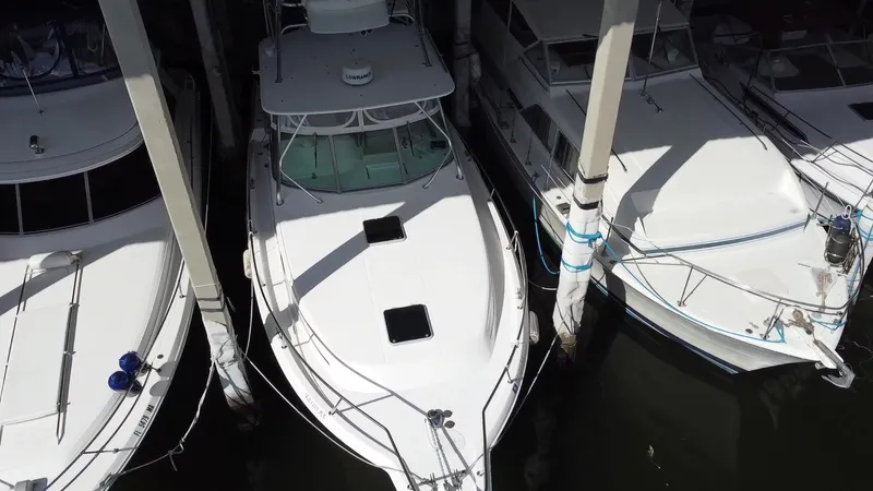  Yacht Photos Pics 2005 Stamas 370 Express boat docked between two others, aerial view.