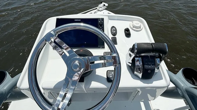  Yacht Photos Pics 2020 Yellowfin 26 Hybrid boat dashboard with steering wheel and controls.