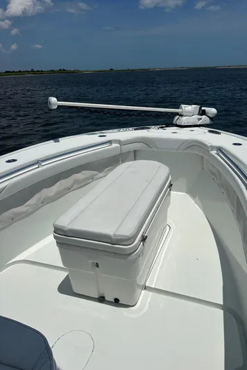  Yacht Photos Pics 2020 Yellowfin 26 Hybrid boat on calm water, featuring a spacious deck and seating.