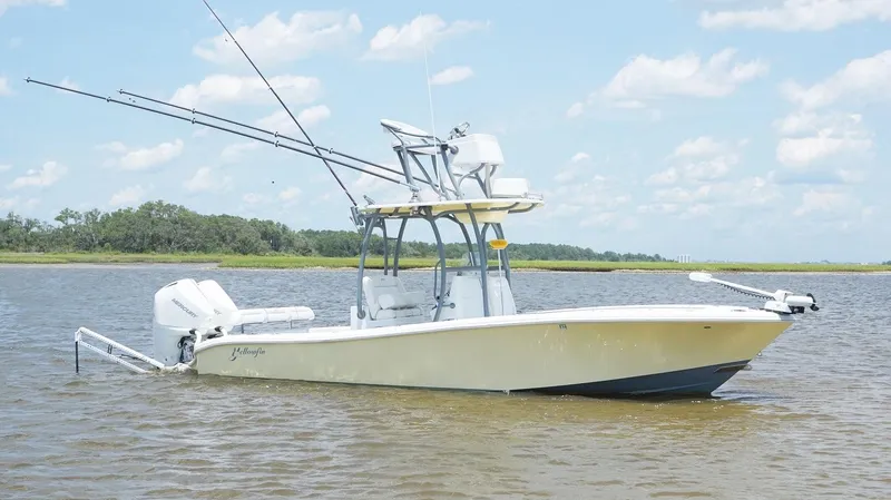  Yacht Photos Pics 2020 Yellowfin 26 Hybrid boat on calm water under a clear sky.