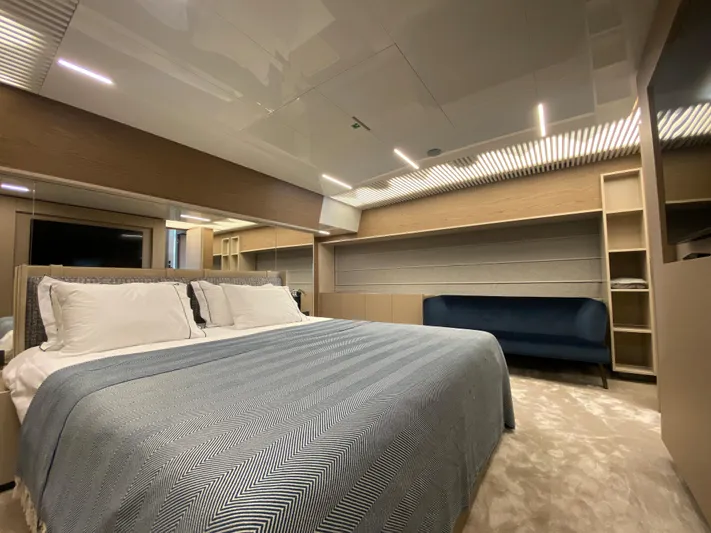 M/y Sunrise Yacht Photos Pics Luxurious bedroom interior of 2021 Ferretti Yachts 920 with modern design and cozy bedding.