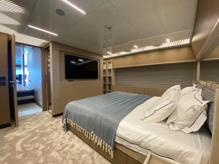 M/y Sunrise Yacht Photos Pics Luxurious bedroom interior of 2021 Ferretti Yachts 920 with modern design and cozy bedding.