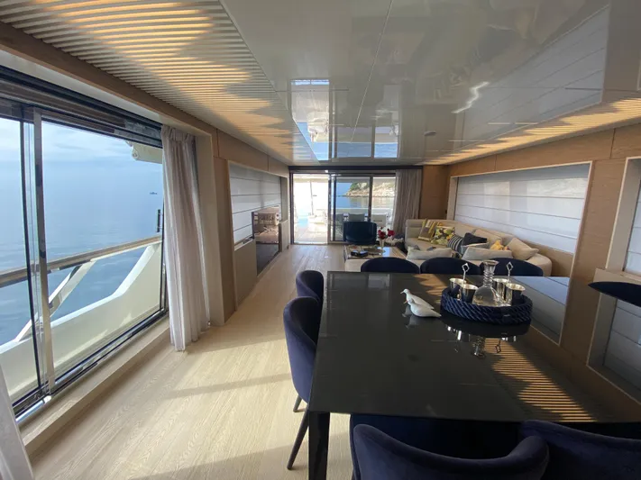 M/y Sunrise Yacht Photos Pics Luxurious interior of 2021 Ferretti Yachts 920 with ocean view and elegant dining area.