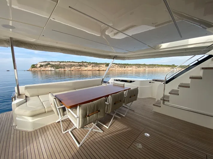 M/y Sunrise Yacht Photos Pics Luxurious 2021 Ferretti Yachts 920 deck with seating, overlooking serene coastal waters.