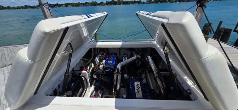  Yacht Photos Pics 2007 Fountain 42 Executioner boat engine compartment with open hatches, docked by a scenic lake.