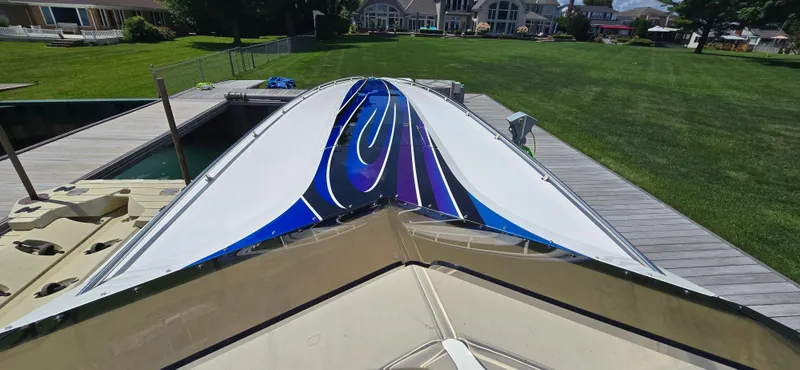  Yacht Photos Pics 2007 Fountain 42 Executioner speedboat with vibrant blue and purple design docked on a sunny day.