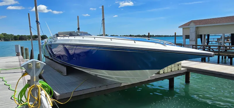  Yacht Photos Pics 2007 Fountain 42 Executioner speedboat docked on a sunny day by the lake.