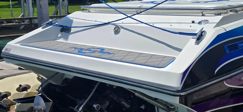  Yacht Photos Pics 2007 Fountain 42 Executioner boat with sleek design and vibrant blue accents at a dock.