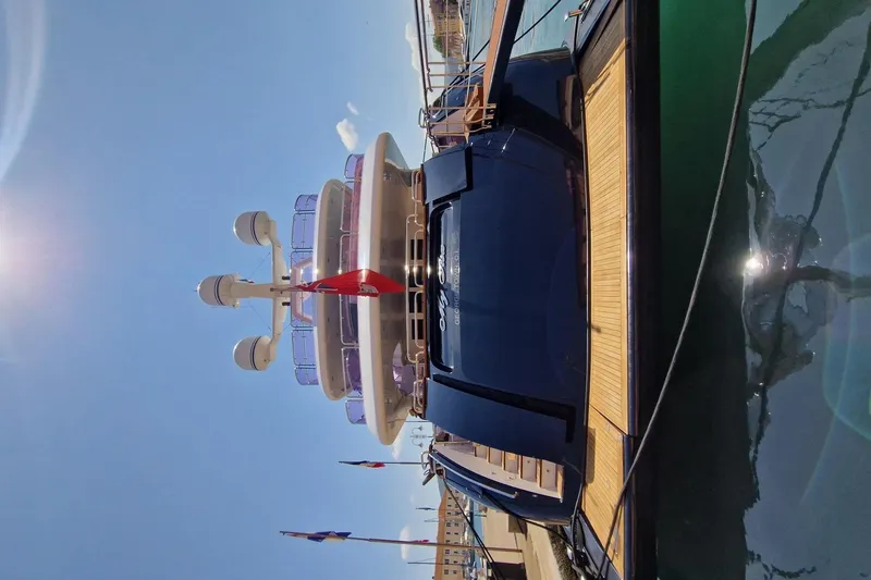  Yacht Photos Pics Luxurious 2010 Benetti Vision 45m yacht docked under clear blue sky.