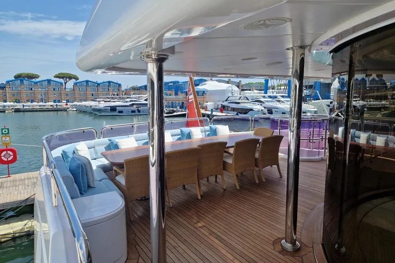  Yacht Photos Pics Luxurious Benetti Vision 45m yacht deck with elegant seating, docked in a scenic marina.