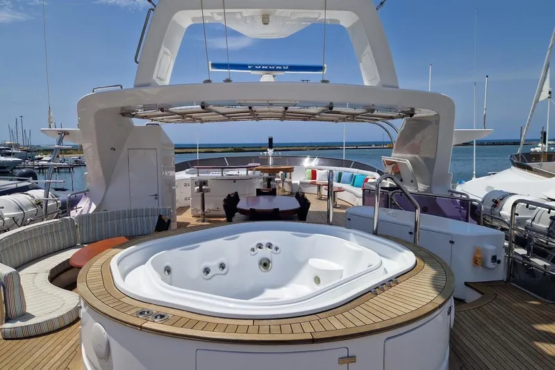  Yacht Photos Pics Luxurious Benetti Vision 45m yacht deck with jacuzzi, seating, and ocean view, 2010 model.