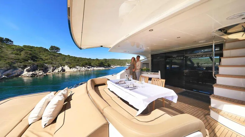  Yacht Photos Pics Luxurious 2011 Princess V85 yacht with elegant outdoor dining area and scenic coastal view.