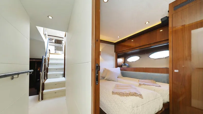  Yacht Photos Pics Luxurious bedroom interior on a 2011 Princess V85 yacht with elegant wood finishes.