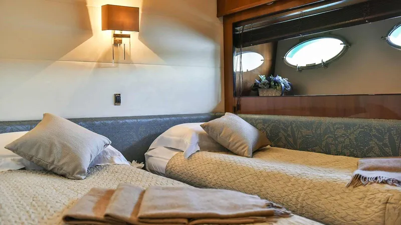  Yacht Photos Pics Luxurious 2011 Princess V85 yacht cabin with twin beds and elegant decor.