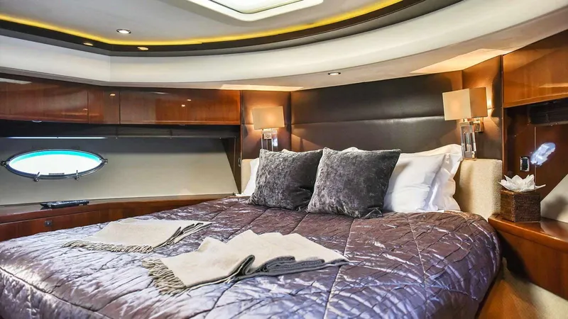  Yacht Photos Pics Luxurious bedroom interior of 2011 Princess V85 yacht with elegant bedding and ambient lighting.