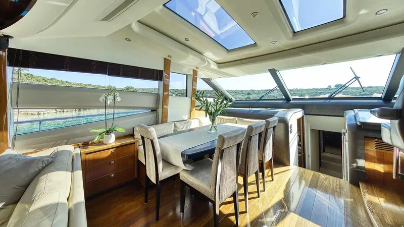  Yacht Photos Pics Luxurious interior of a 2011 Princess V85 yacht with elegant dining area and panoramic windows.
