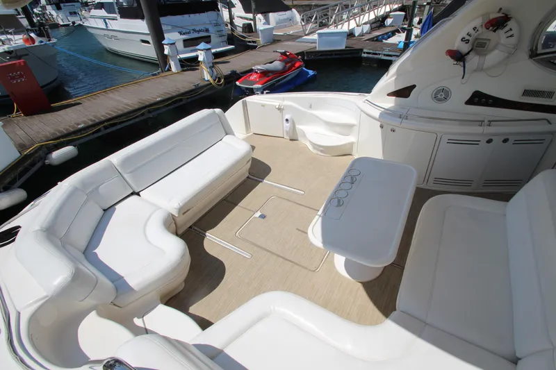  Yacht Photos Pics 2003 Sea Ray 550 Sundancer yacht with spacious seating and table at marina.