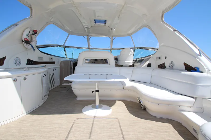  Yacht Photos Pics Luxurious interior of 2003 Sea Ray 550 Sundancer yacht with white seating and table.