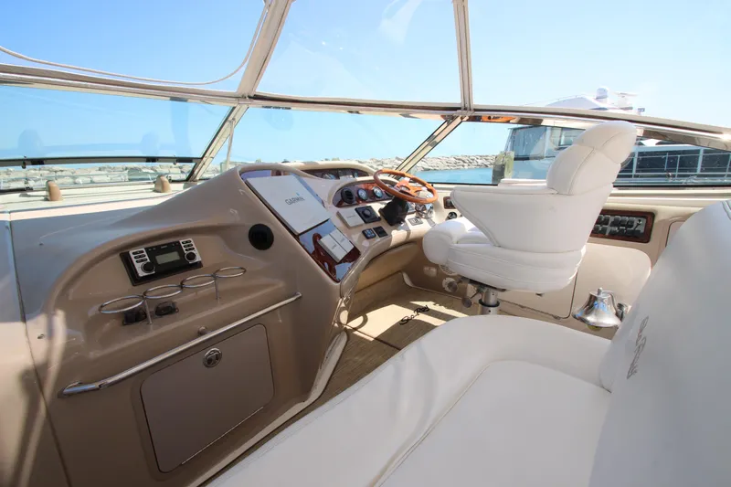  Yacht Photos Pics 2003 Sea Ray 550 Sundancer helm with luxurious seating and modern controls.